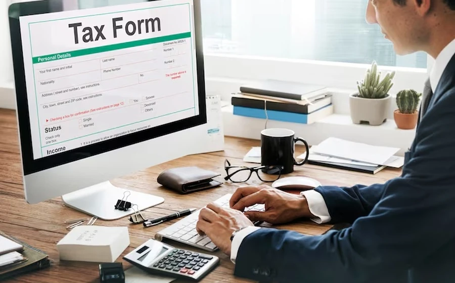 Person preparing taxes at a desk